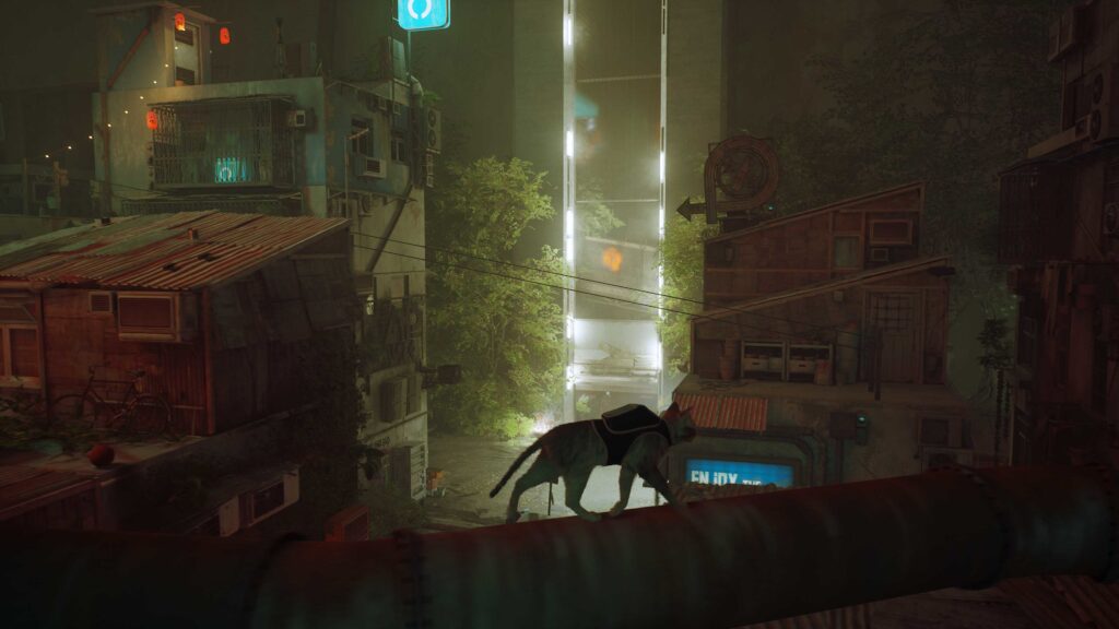 The Stray cat is a silhouette as he walks across a high beam over the city. The city below and behind him is mostly shrouded in darkness with some white neon lights in the middle