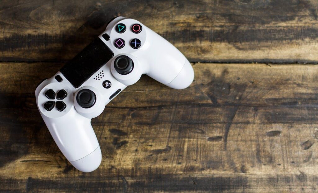 White Playstation controller on a wooden setting