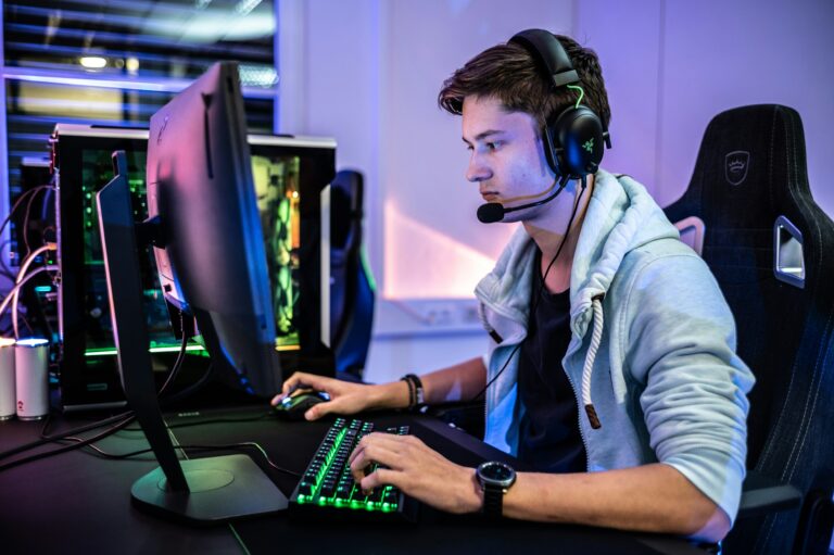 Image of an eSports player at their setup with headphones and mic